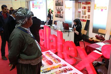 A man in traditional Kurdish dress looks at a stand at the Irbil Oil and Gas Exhibition on Friday, April 24, 2015 in Irbil, Iraq. The Kurds estimate their autonomous region in northern Iraq holds some 45 billion barrels and have made no secret of their desire to use this potential source of income for further independence from the central government, but thanks to lower prices and instability, dreams of financial independence maybe farther away than ever. (AP Photo/Bram Janssen)