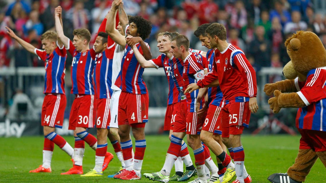 Bayern Munich players acknowledge their fans after winning Bundesliga first division soccer match against Hertha Berlin in Munich. Reuters