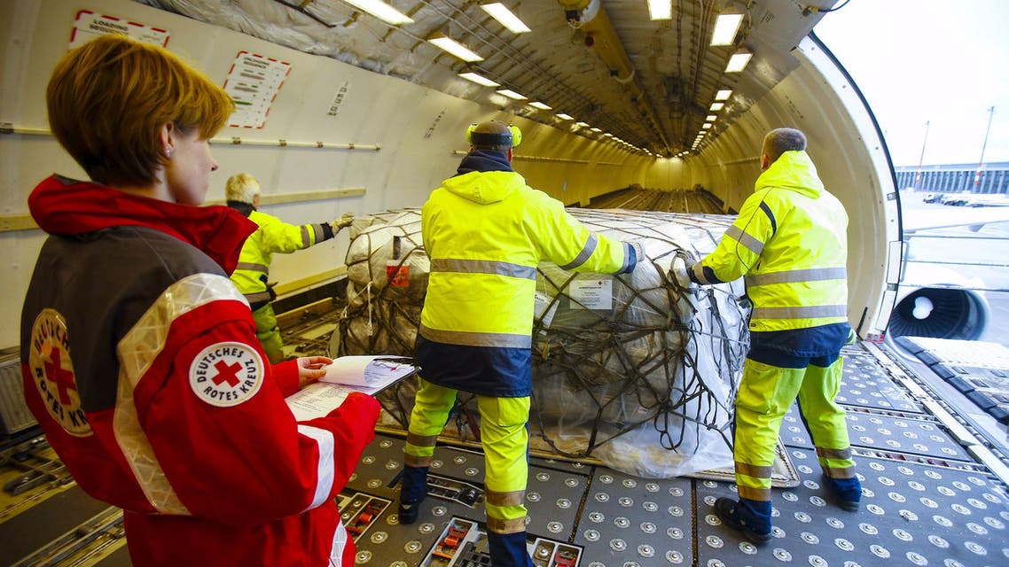 Workers load humanitarian aid from German Red Cross (DRK) for victims of the earthquake in Nepal, into an aircraft at Schoenefeld airport outside Berlin Reuters
