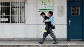 ‘Beautiful student’ in China carries disabled friend to class for 3 years 