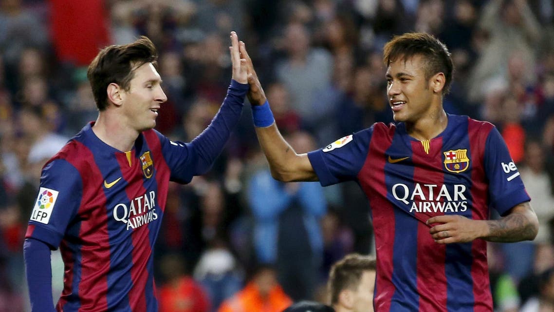Barcelona's Lionel Messi and Neymar celebrates Xavi Hernandez's goal against Getafe during their Spanish first division soccer match at Nou Camp stadium in Barcelona. Reuters