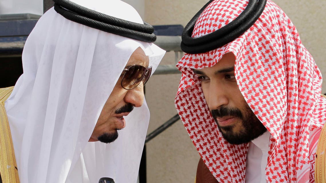 File photo shows King Salman bin Abdul-Aziz Al Saud (L) speaks with his son Prince Mohammed in Riyadh, Saudi Arabia. (AP)