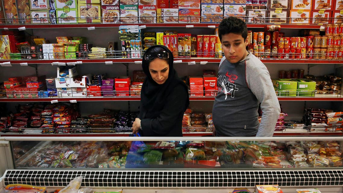 Iranians shop in a supermarket in north Tehran, Iran, Wednesday, April 29, 2015. Iran has scrapped the country's wealthiest citizens off a list of people receiving monthly cash handouts in a small step toward easing the burden on the budget and freeing up more government funds, an official said Wednesday. The move, which will free up about $3 million a month of government money, is the latest in Tehran's efforts to juggle cash and wean the nation off subsidies in an oil-dependent economy suffering from a steep drop in global oil prices. (AP Photo/Vahid Salemi)