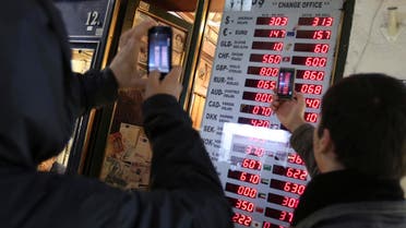 Turks look at currency charts (AP)