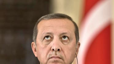 Turkish President Recep Tayyip Erdogan looks up during a press conference at the Cotroceni presidential palace in Bucharest, Romania, Wednesday, April 1, 2015. Two members of a banned leftist group and a prosecutor they held hostage inside a courthouse in Istanbul died Tuesday after a shootout between the hostage takers and police, officials said. Erdogan is on an official visit to Romania. (AP Photo/Vadim Ghirda)