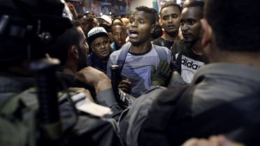  Israeli Ethiopians face Israeli police in the main street of downtown Jerusalem on April 30, 2015, during a protest to demand an investigation into alleged police racism and violence.  (AFP)