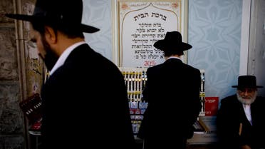 Ultra-orthodox Jewish men shop before Shabbat in the Mea Sharim neighborhood, Jerusalem, Friday, Nov. 12, 2010.  (AP)