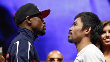 Floyd Mayweather Jr., left, and Manny Pacquiao pose during their weigh-in on Friday, May 1, 2015 in Las Vegas. (AP)