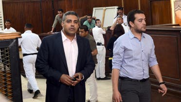Journalists Mohamed Fahmy (L) and Baher Mohamed are seen at a court in Cairo after their retrial on April 22, 2015. (Reuters)