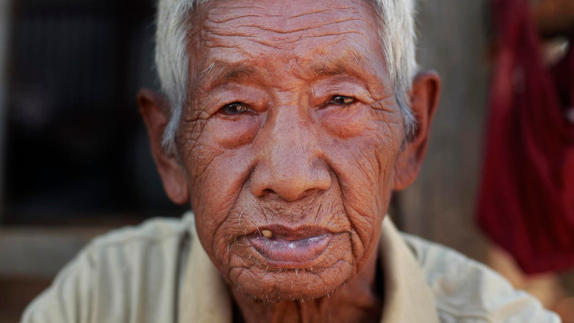 Fattha Bahadur Rana, 90, sits in the rubble of his collapsed home in the destroyed village of Pokharidanda, near the epicenter of the April 25 massive earthquake, in the Gorkha District of Nepal. (AP)