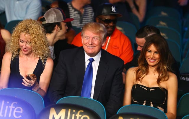 Donald Trump (middle) and wife Melania Trump (right) in attendance before the welterweight boxing fight. (Reuters)