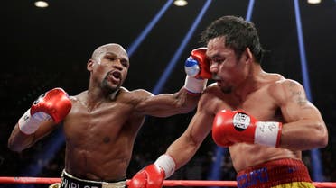 Floyd Mayweather hits Manny Pacquiao during their welterweight title fight on Saturday. (AP Photo/Isaac Brekken)