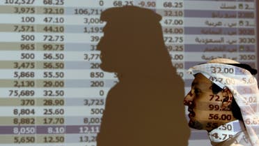 A Saudi trader walks past a stock market monitor in Riyadh, Saudi Arabia, Tuesday. (File: AP)