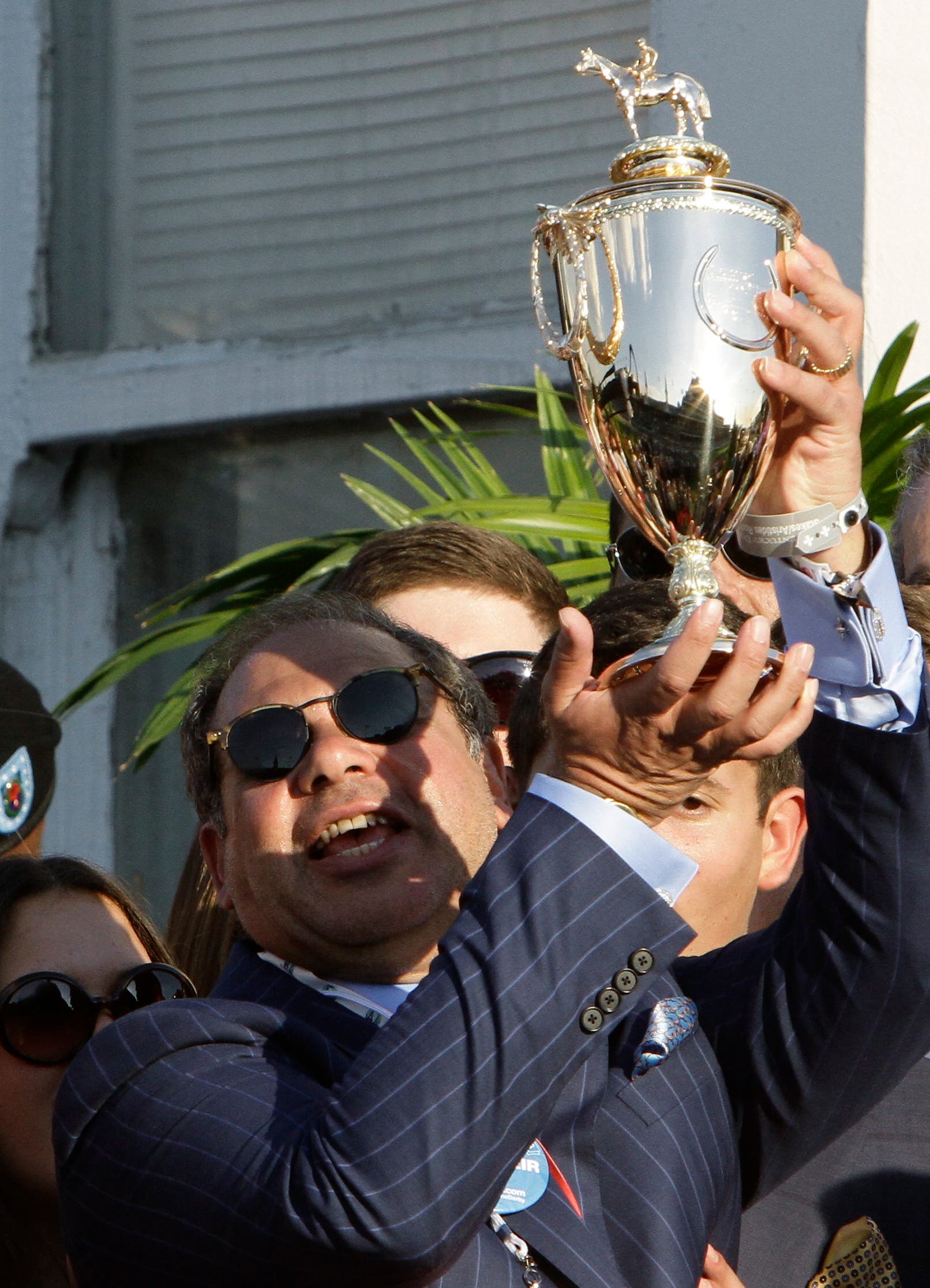 American Pharoah owner Ahmed Zayat holds the trophy after Victor Espinoza rode American Pharoah to victory at the Kentucky Derby horse race at Churchill Downs. (AP)