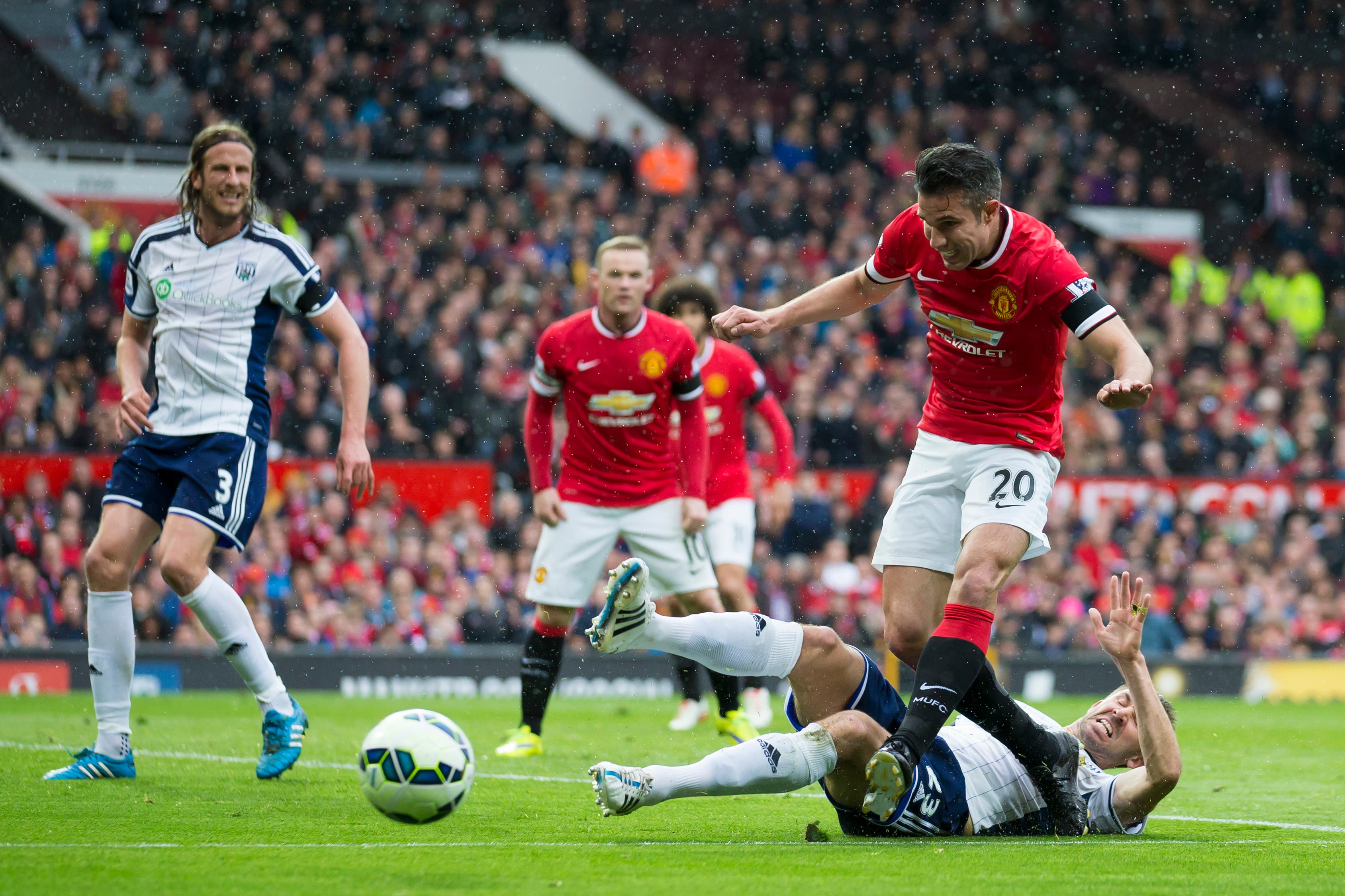 Manchester United's Robin van Persie, upper right, is tackled by West Bromwich Albion's Gareth McAuley during the English Premier League soccer match between Manchester United and West Bromwich Albion at Old Trafford Stadium, Manchester, England, Saturday, May 2, 2015. (AP Photo/Jon Super)