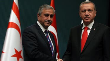 Turkish President Recep Tayyip Erdogan, right, and newly elected Turkish Cypriot leader Mustafa Akinci shake hands after a joint press conference in Ankara, Turkey, Wednesday, May 6, 2015. Akinci is in Ankara on a one-day official visit.(AP Photo/Burhan Ozbilici)