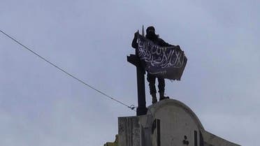  In this file photo posted on the Twitter page of Syria's al-Qaida-linked Nusra Front on Saturday, March 28, 2015, which is consistent with AP reporting, a fighter from Syria's al-Qaida-linked Nusra Front holds his group flag in Idlib province, north Syria. In the span of a month, a coalition of Syrian insurgents has routed government forces across the country's northwest, flushing them out of strongholds in a string of embarrassing loses for President Bashar Assad. (Al-Nusra Front Twitter page via AP, File)