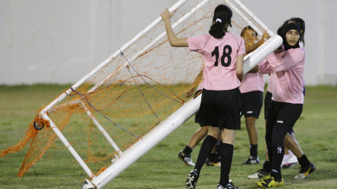 In this photo taken on Sunday, April 25, 2010, Alla Ahmed, right, from Egypt, carries the goal frame with her teammates during a training session of the United Arab Emirates (UAE) women's soccer team in Abu Dhabi, United Arab Emirates. Recently, the UAE women's soccer team scored their greatest triumph, making their first appearance in a major tournament. Playing live on national television _ and in front of a boisterous crowd of several hundred men _ the Gulf upstarts stunned reigning champion Jordan 1-0 in the West Asian Football Federation championship.(AP Photo/Kamran Jebreili)