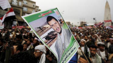 Houthi follower holds up a poster of leader of the Houthi group Abdul Malik Badruddin al-Houthi during a demonstration against the Saudi-led air strikes, in Sanaa. Reuters 
