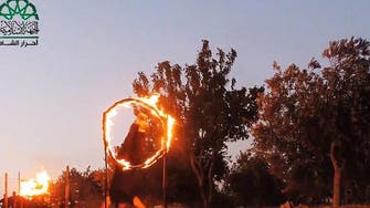 Syria militants seen jumping through flaming hoops