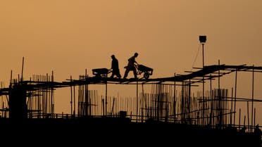 Pakistani laborers are silhouetted against the skyline as they work on the top of a construction site in Islamabad, Pakistan, Wednesday, March 14, 2012. (AP Photo/Anjum Naveed)