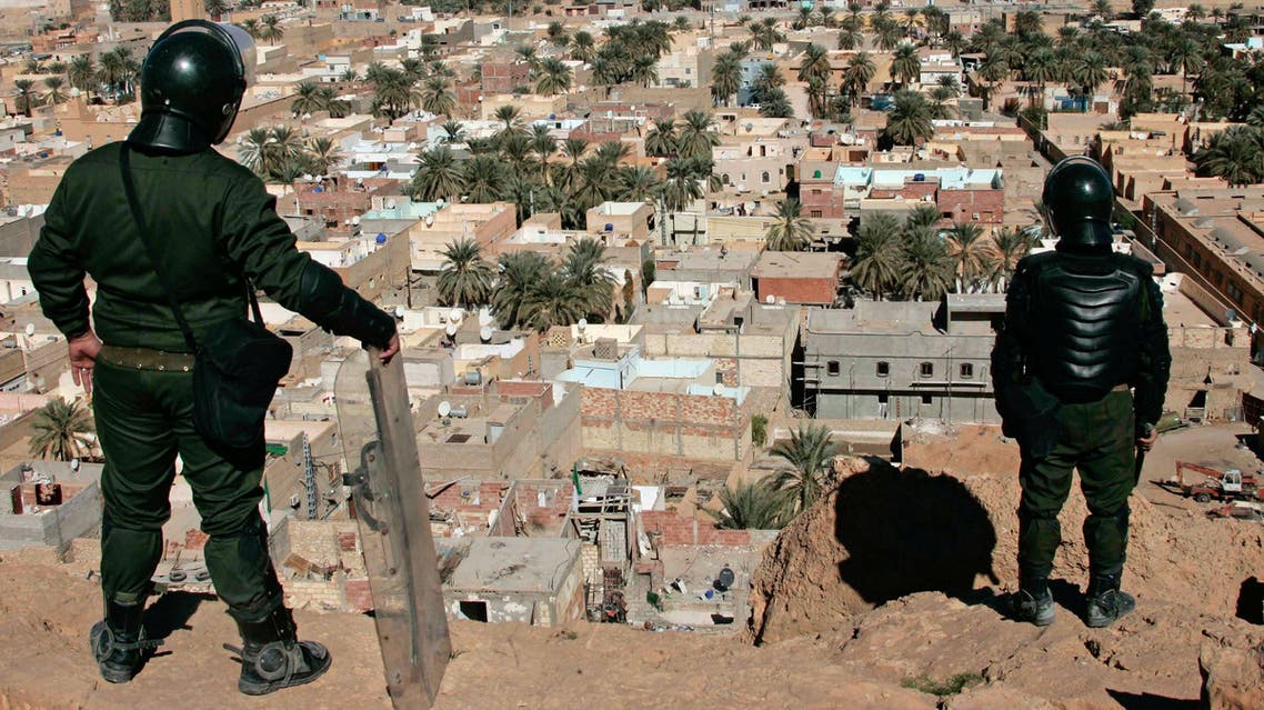 Algerian police officers watch over the desert city of Ghardaia, southern Algeria, after a Berber died of his wounds on Thursday, Ghardaia, Saturday, Feb. 8, 2014.