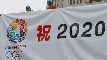 Workers hang a banner celebrating the city's successful bid to host the 2020 Summer Olympics as they prepare for an official event by the Tokyo Municipal Government to report the news to Tokyo citizens at the government office square in Tokyo Sunday morning, Sept. 8, 2013. AP 