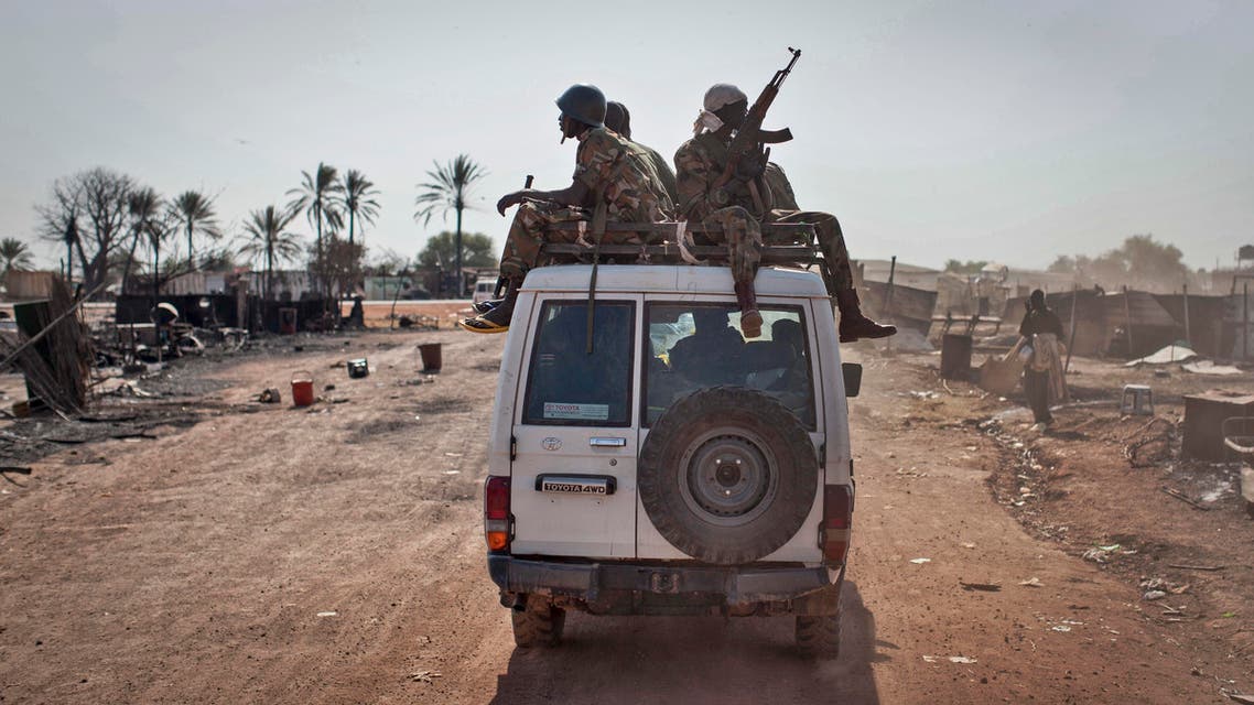 outh Sudanese government forces ride on a vehicle through the still-smoldering town, after government forces on Friday retook from rebel forces the provincial capital of Bentiu, in Unity State, South Sudan, Sunday, Jan 12, 2014. AP