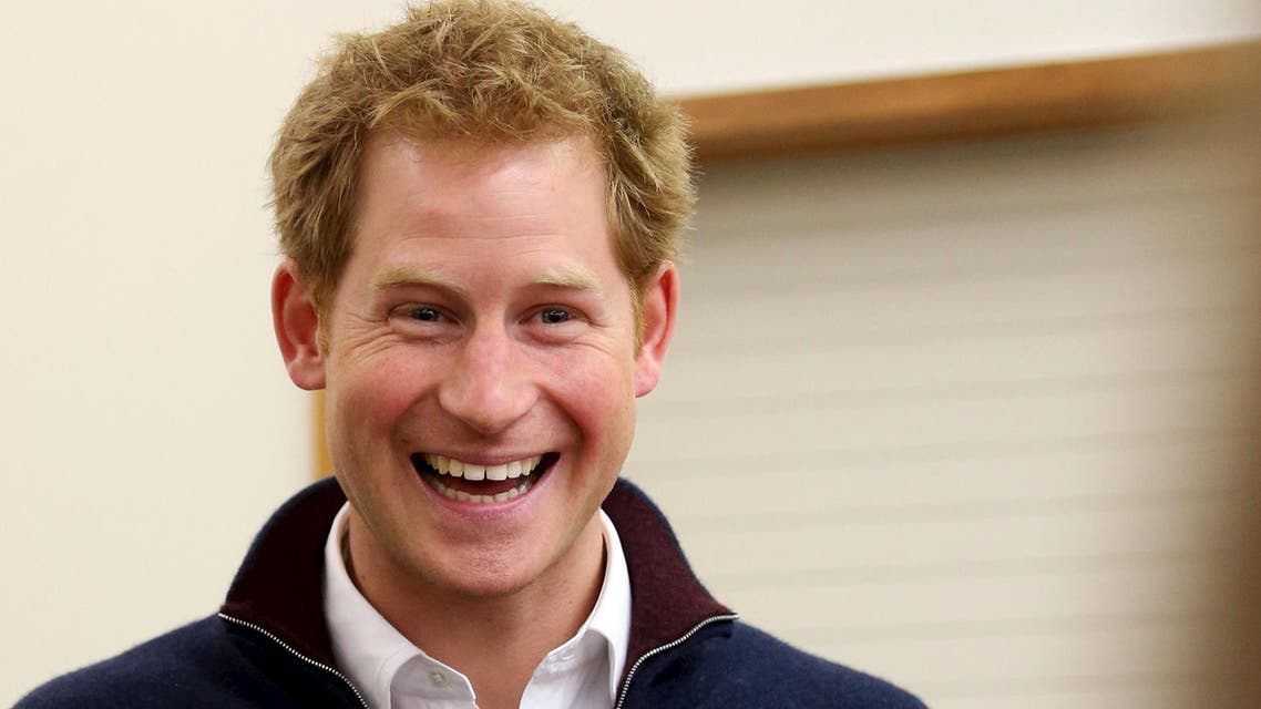 Britain's Prince Harry laughs as he meets locals at the Stewart Island community center during his visit to Stewart Island in the south of New Zealand, May 10, 2015. REUTERS/Dianne Manson/Pool