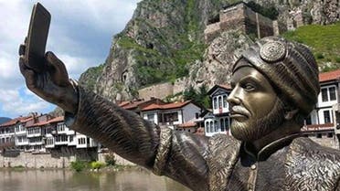 This May 10, 2015 photo shows a statue of an Ottoman prince taking a selfie with a cellphone erected in Amasya, Turkey. (AP)