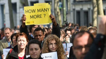A protestor holds up a sign as others carry a mock coffin of a migrant during a demonstration outside of an emergency EU summit in Brussels on Thursday, April 23, 2015. (File Photo: AP)