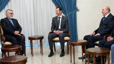 A handout picture released by the official Syrian Arab News Agency on May 13, 2015 shows President Bashar al-Assad (C) meeting with Chairman of the Iranian Shura Council’s Committee for Foreign Policy and Syria's security services chief Ali Mamluk in Damascus. (AFP)