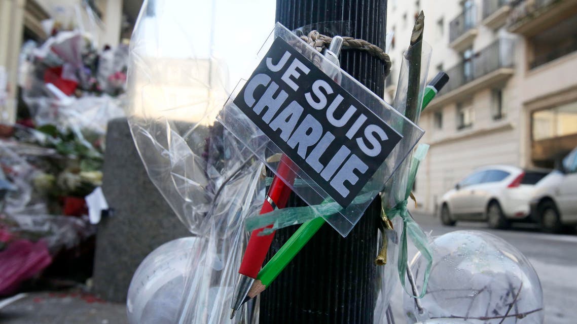 Flowers are laid near the headquarters of magazine Charlie Hebdo in Paris, Friday Feb. 6, 2015. AP