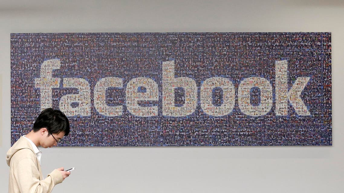 In this Wednesday, June 11, 2014 photo, a man walks past a sign in an office on the Facebook campus in Menlo Park, Calif. One more time, Facebook is trying to simplify its lengthy privacy policy — and make it much shorter — to explain how it targets advertisements to its 1.35 billion users. (AP Photo/Jeff Chiu)