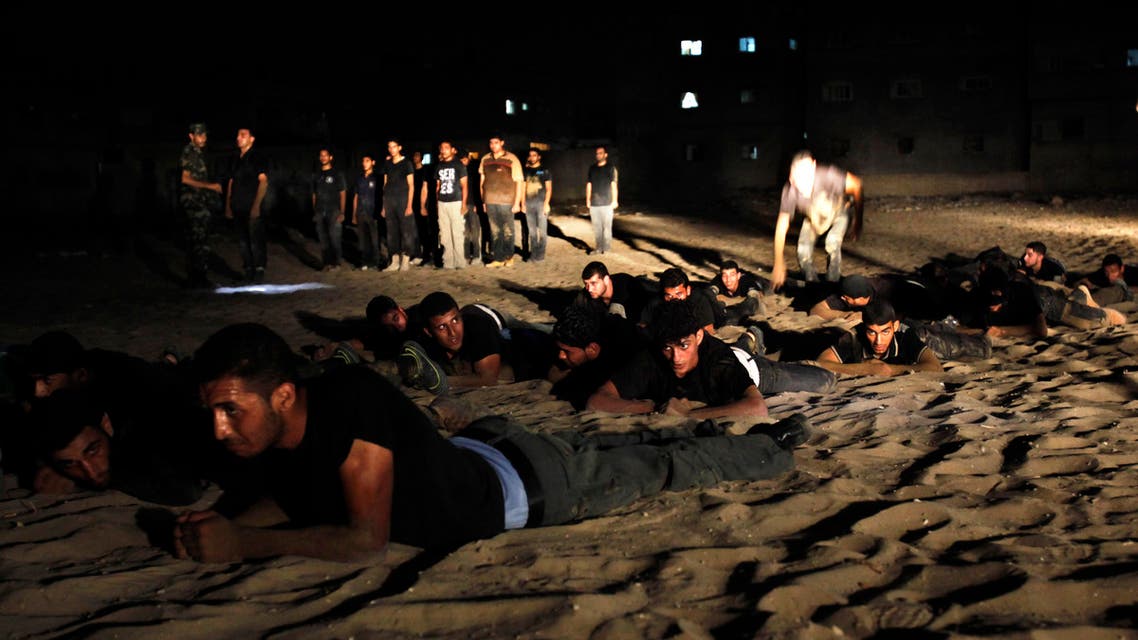 Palestinian youths crawl during a night military-style exercises run by militants from the al-Nasser Brigades, an armed wing of the Popular Resistance Committees (PRC), at their training camp in Gaza City. (File: AP)