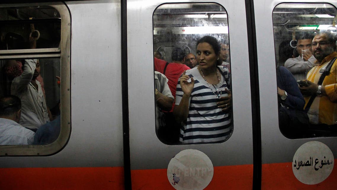 In this April 29, 2015 photo, people ride a car at the Ataba metro station, in Cairo, Egypt. AP