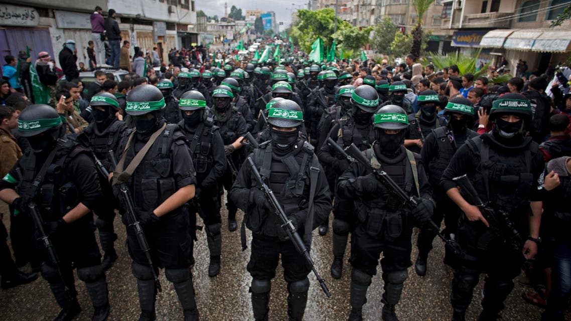 In this Dec. 14, 2014 file photo, masked Palestinian Hamas gunmen perform their military skills during a rally to commemorate the 27th anniversary of the Hamas militant group, in Gaza City. AP