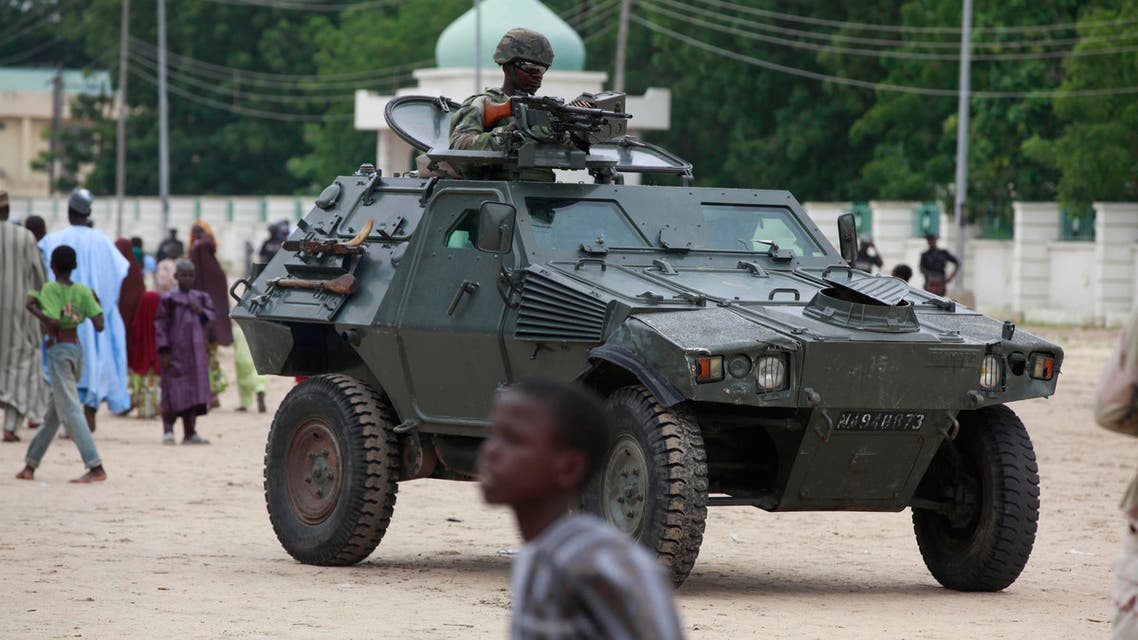 Nigerian soldiers ride on an armored personnel carrier during Eid al-Fitr celebrations in Maiduguri, Nigeria. AP