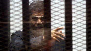 Ousted Egyptian President Mohamed Mursi is seen behind bars during his trial at a court in Cairo. Reuters 