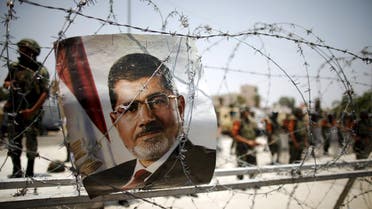 A portrait of deposed Egyptian President Mohamed Mursi is seen on barbed wire outside the Republican Guard headquarters in Cairo. (File: Reuters)