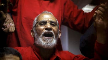 Muslim Brotherhood's Supreme Guide Mohamed Badie (C) reacts with other brotherhood members at a court in the outskirts of Cairo, Egypt May 16, 2015. (Reuters)