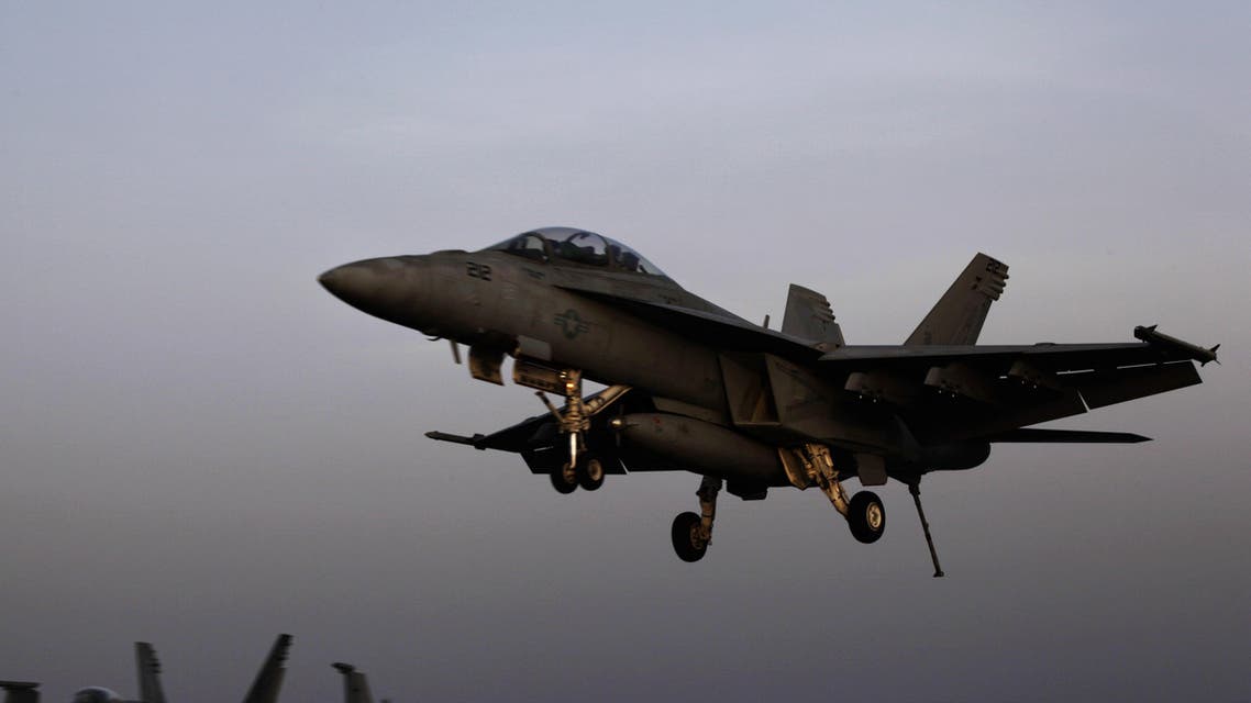 an aircraft lands after missions targeting the Islamic State group in Iraq from the deck of the U.S. Navy aircraft carrier USS George H.W. Bush in the Persian Gulf.