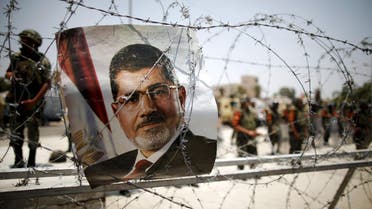 File picture shows a portrait of deposed Egyptian President Mohamed Mursi on barbed wire outside the Republican Guard headquarters in Cairo. (Reuters)