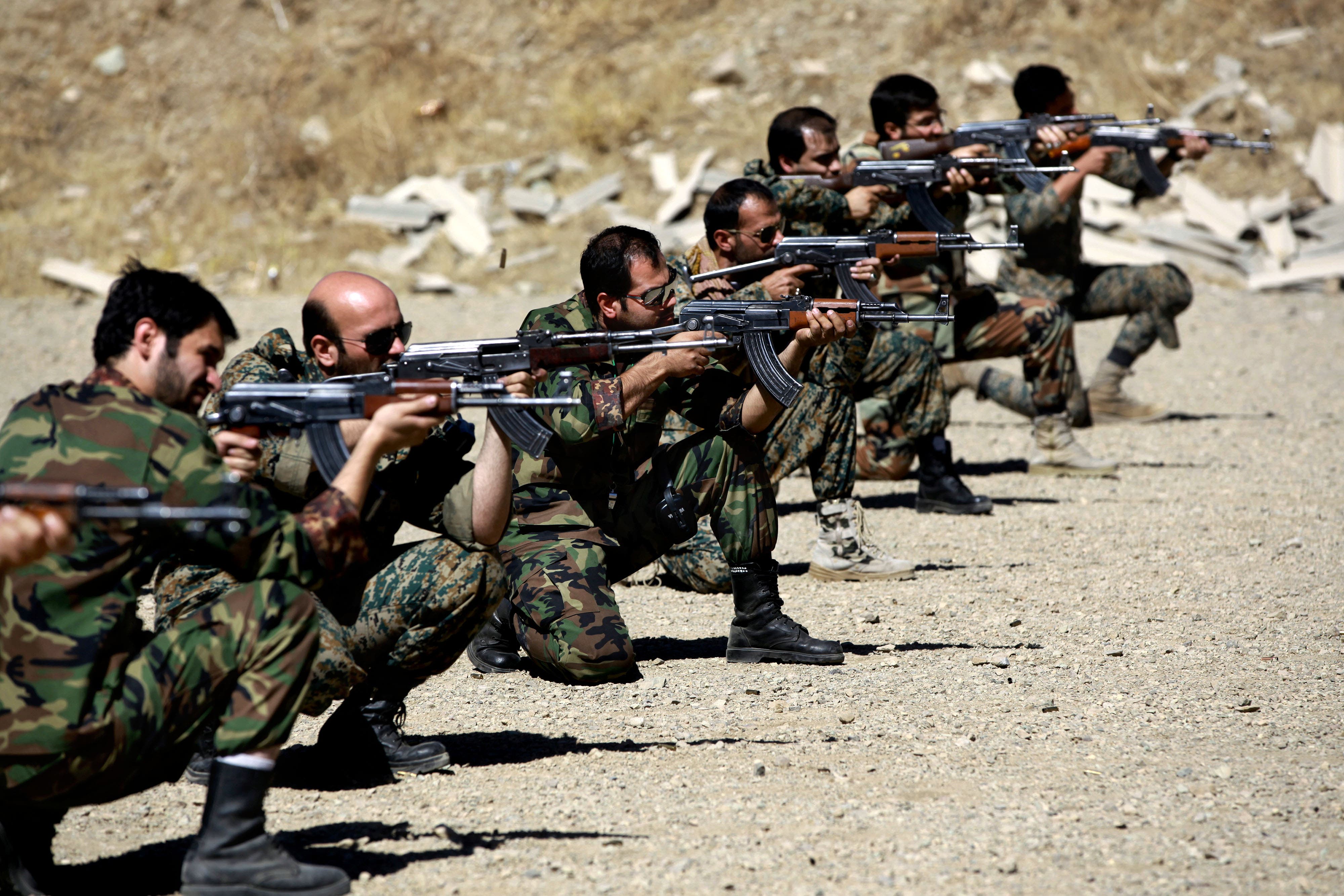 In this Thursday, Sept. 19, 2013 photo, members of the Basij paramilitary militia fire their weapons during a training session, in Tehran, Iran. AP