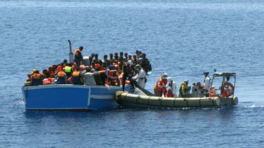 This photo provided by the Italian Navy's Press Office Monday, May 4, 2015 shows members of an an Italian Navy unit, on the dinghy at right, as they rescue migrants in the Mediterranean Sea. (AP)