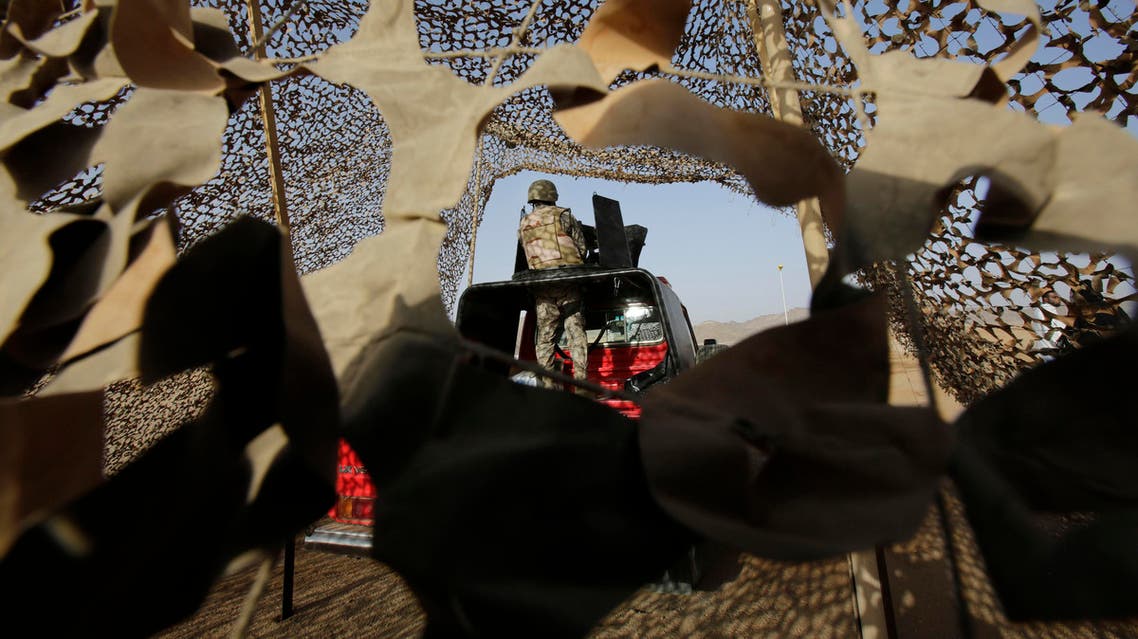 FILE - In this Tuesday, April 21, 2015 file photo, a Saudi soldier stands alert, on the Saudi-Yemen border in Najran, Saudi Arabia. A cross-border attack on Saudi Arabia by Yemeni rebel forces resulted in late-night clashes on Thursday, April 30, 2015 that left three Saudi soldiers and "dozens" of Yemeni rebels dead, according to the Saudi Defense Ministry. (AP Photo/Hasan Jamali, File)