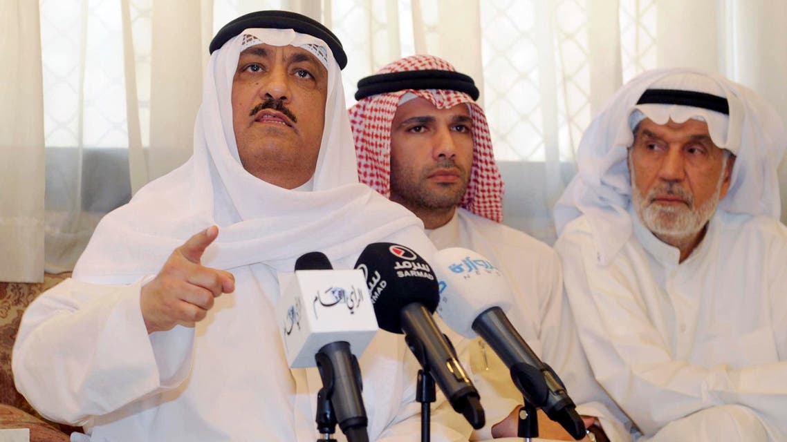 Former Kuwaiti lawmaker Musallam al-Barrack, left, speaks at his residence after Kuwait's supreme court upheld a verdict on charges he insulted the country's ruler, in Kuwait city, Kuwait, Monday, May 18, 2015. AP