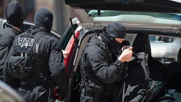 Elite police officers from the GIPN brigade arrive at a bank after a gunman took four people hostage in a bank in the southern French city of Toulouse and fired a shot, police said, Wednesday, June 20, 2012.AP