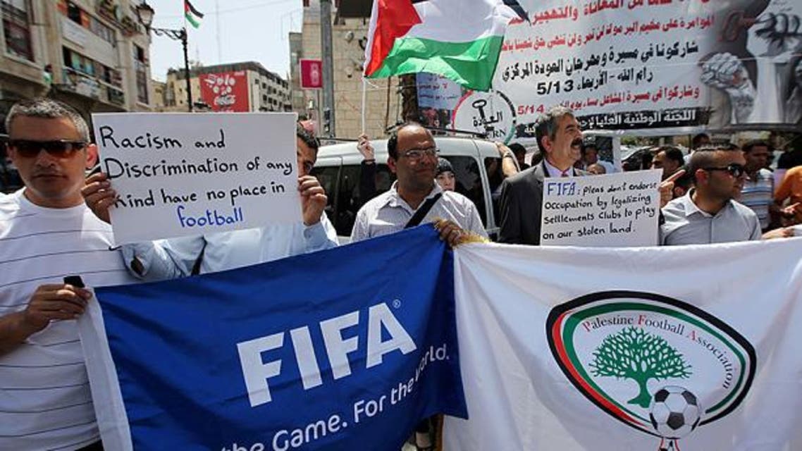 Palestinians hold banners as they demonstrate in Ramallah demanding the expulsion of Israel from FIFA AFP