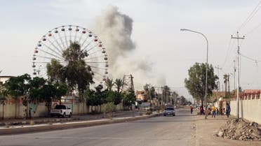 In this Saturday, May 9, 2015 photo, smoke rises after an airstrike by the U.S.-led coalition on Islamic State group positions in an eastern neighborhood of Ramadi, the capital of Anbar province, 70 miles (115 kilometers) west of Baghdad, Iraq. Iraqi authorities on Friday signed up the first batch of 1,000 recruits for a new Sunni militia to help its security forces take back the western Anbar province from the Islamic State group, after years of reluctance to arm and train the tribal fighters. (AP Photo)